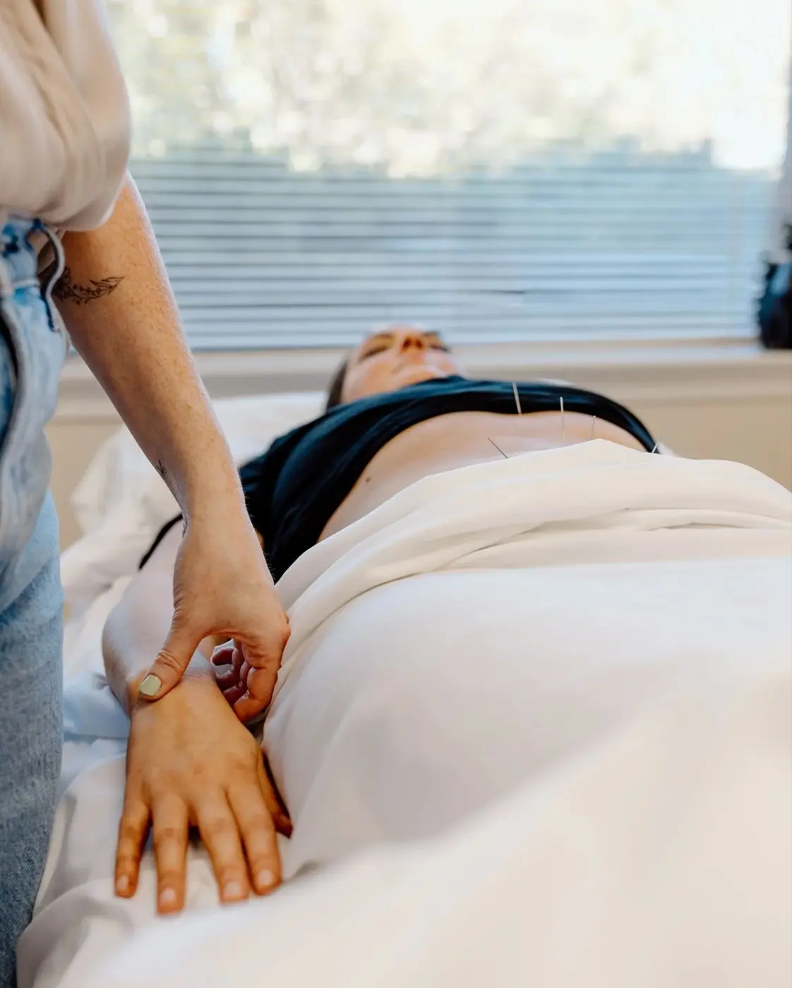 Patient resting comfortably during a licensed acupuncture treatment